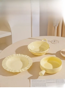 Detailed close-up of cream ceramic dinnerware set with elegant underglaze finish
