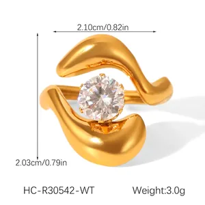 Detailed macro of gold curved geometric ring with sparkling round zircon centerpiece