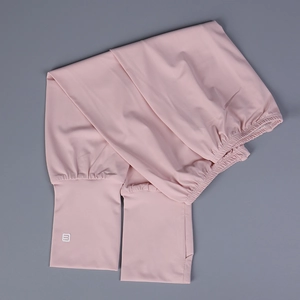 Detail of light pink ice silk sun sleeves with thumb holes and white logo on the cuff
