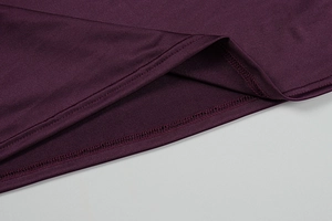 Detail of double-needle stitching on the hem of a burgundy lace bodycon mini dress