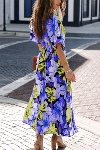 Floral maxi dress with purple and yellow print showing back waist detail and elegant flow