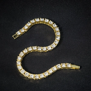 Detail view of 4mm gold tennis chain featuring round brilliant cut cubic zirconia stones