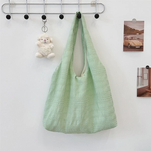 Detail of light green pleated tote bag fabric texture and large capacity design