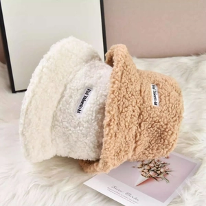 Plush lamb wool bucket hats in beige and caramel with letter patch for winter warmth