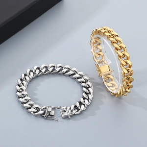 Detail of silver and gold Cuban curb chains with secure clasp on neutral background