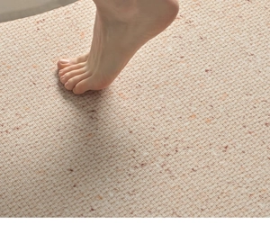 Close-up of minimalist beige woven rug texture with red dots being stepped on