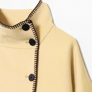 Women's light yellow high-neck wool jacket with black buttons and contrast stitching details