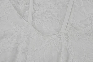 Close-up of white floral mesh lace texture and thin shoulder strap of a summer dress