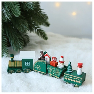 Macro shot of dark green wooden Christmas train with bear and snowman on faux snow