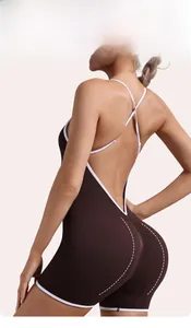 Detail of ribbed yoga jumpsuit featuring criss-cross back straps and a bum lifting design