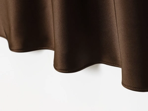 Close-up of the smooth hemline on a brown satin midi skirt showing silky fabric texture
