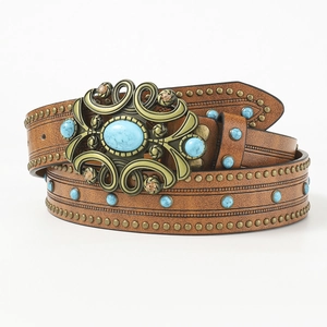 Vintage brown leather belt with turquoise inlay and ornate brass buckle on white background