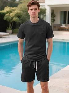 Detail of charcoal waffle knit fabric texture on men's summer t-shirt and drawstring shorts