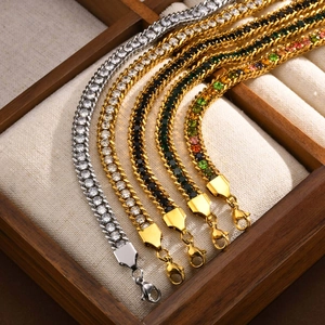 Detailed view of gold and silver cuban link bracelets with colorful cubic zirconia stones