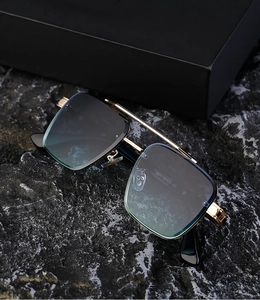Close-up of rimless sunglasses temple showing model number 5G77 on metal frame