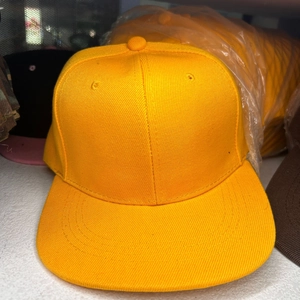 Close-up of bright yellow flat brim hip hop hat with detailed six-panel cotton stitching