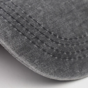 Detail of grey washed cotton baseball cap brim with durable parallel reinforced stitching