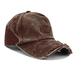 Close-up of distressed brown washed cotton baseball cap with embroidered Boston logo