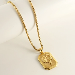 Close-up of 18K gold stainless steel pendant featuring a 3D embossed dragon on a box chain