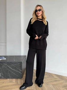 Women's black knit 2-piece set featuring cutout sweater and high-waist wide-leg pants
