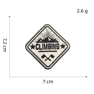 Macro shot of mountain embroidery patch with CLIMBING text and cross tools detail