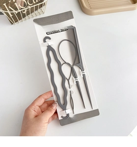 Detail of 4pcs grey hair styling tool set with topsy tail tools and comb on packaging