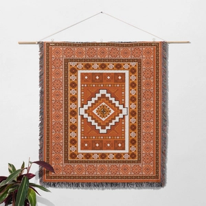 Detail of woven bohemian wall hanging featuring geometric patterns and colorful fringe