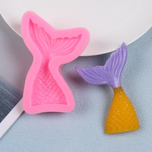 Detailed pink silicone mold for mermaid tails featuring realistic scale textures and finished pieces