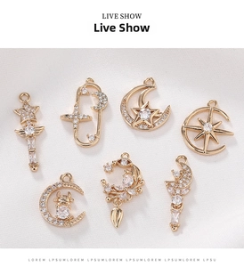 Detailed view of gold plated pendants with cubic zirconia stars and moon designs