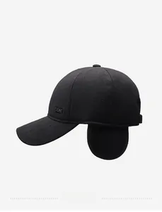 Detail view of winter baseball cap with ear flaps and black metallic brand logo