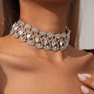 Close-up of vintage silver choker with intricate hollow geometric patterns and clear rhinestones