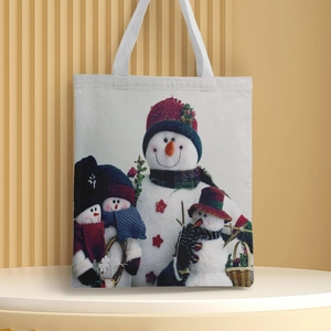 Detailed close-up of Christmas snowman family print on a durable canvas tote bag