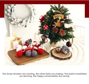 Detailed close-up of Christmas wool felt ornaments set on wooden tray with warm holiday decor