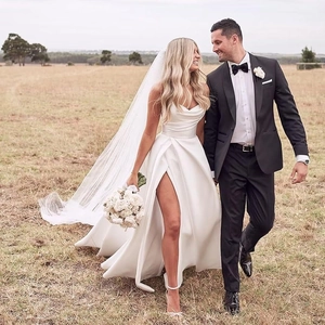 Elegant white satin wedding dress with a strapless sweetheart neckline and high leg slit