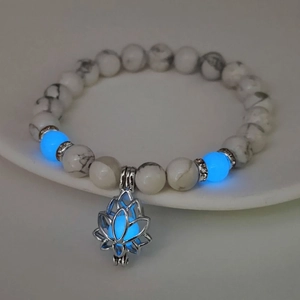 Luminous lotus charm bracelet with white turquoise beads and glowing blue accents