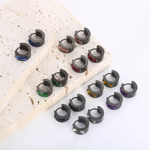 Macro shot of assorted colorful crystals set in black stainless steel hoop earrings