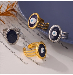 Detailed close-up of evil eye rings with blue enamel on open vintage book pages