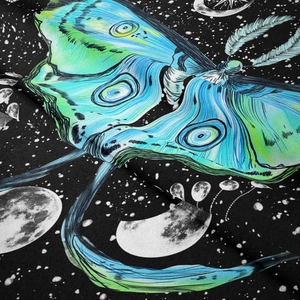 Close-up of soft fabric texture featuring celestial moth print and stars