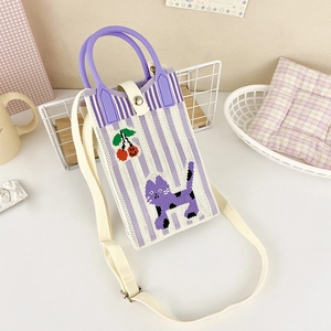Detail of cute purple knitted phone bag with cat pattern and adjustable shoulder strap