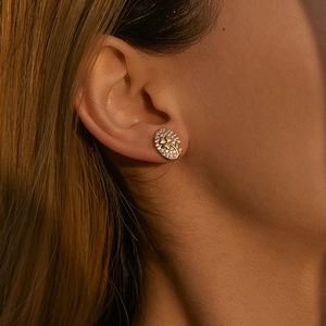 18K gold-plated oval stud earrings with pavé clover pattern shown on model ear