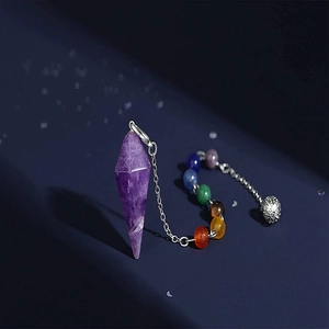 Amethyst hexagonal pendulum necklace with seven chakra beads on a dark background