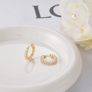 Close-up of S925 sterling silver gold hoop earrings with micro-pave cubic zirconia stones