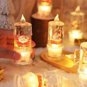 Close-up of a glowing LED Santa water candle with swirling glitter and warm light