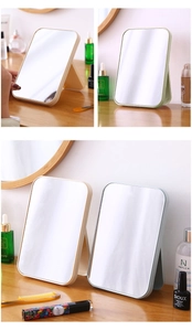 Foldable minimalist makeup mirror with adjustable stand shown in various soft colors