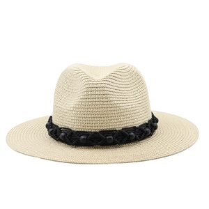 Summer Panama straw hat with black beads band on minimalist white background