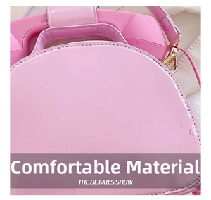 Detail of creative pink telephone handbag showing handset handle and volume controls