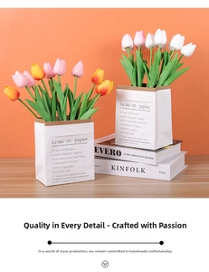 Close-up of colorful artificial tulip bouquets in white paper bags on a wooden table