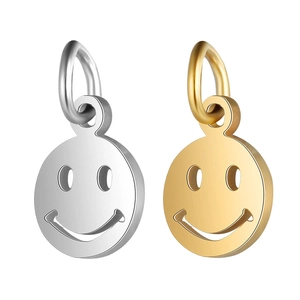 Detailed view of round smile face stainless steel pendants in silver and gold finish
