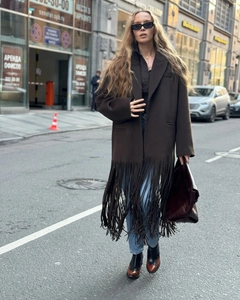 Close-up of deep brown long coat with fringe detailing and stylish street wear movement