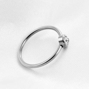 Macro shot of 2mm silver stainless steel ring featuring a sparkling round zircon stone